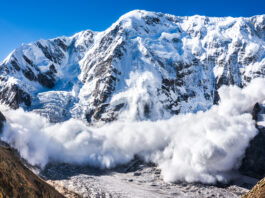 Large avalanche coming down the rocky Caucasus mountain