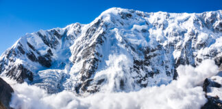 Large avalanche coming down the rocky Caucasus mountain