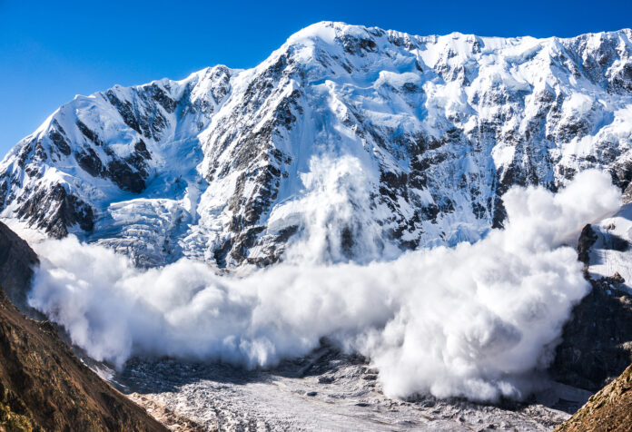 Large avalanche coming down the rocky Caucasus mountain